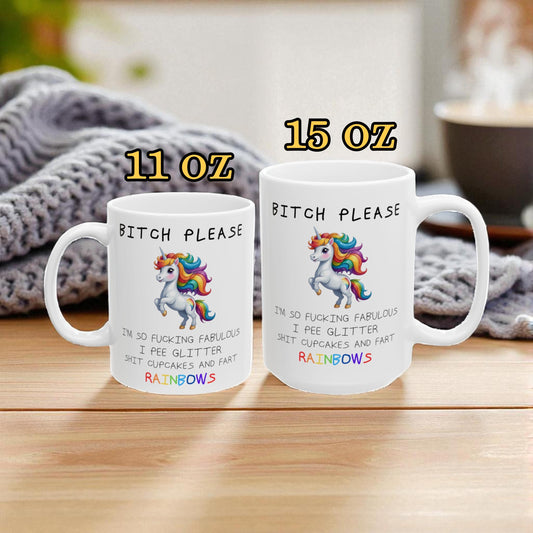 Two coffee mugs with funny sayings and unicorn designs on a wooden surface